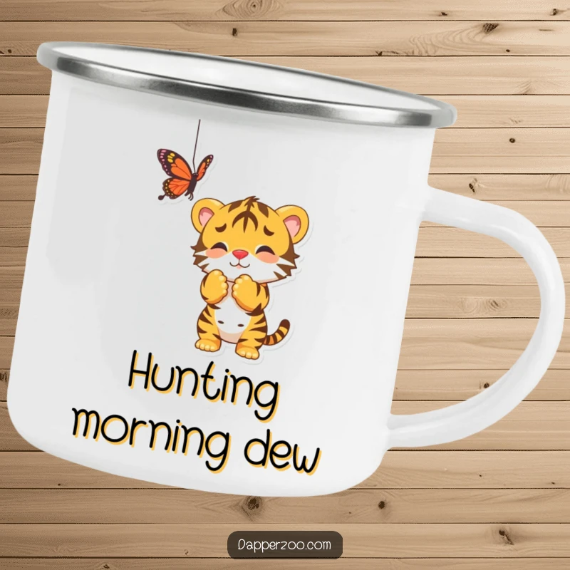 Funny camping mug showing a playful tiger cub batting at a dangling butterfly, perfect for outdoor fun.