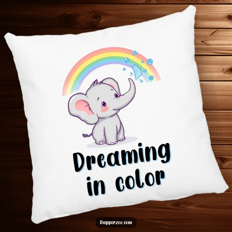 A tiny elephant sprays water from its trunk to create a rainbow on this soft and funny pillow.