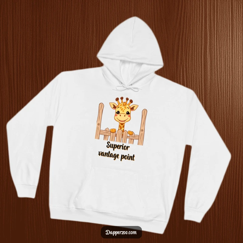 Funny giraffe hoodie with a big grin, comically peeking over a tall fence, perfect cozy gift for animal lovers.