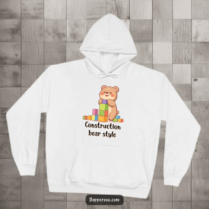 Funny hoodie with a happy bear building a precarious tower of colorful blocks, a perfect warm gift.