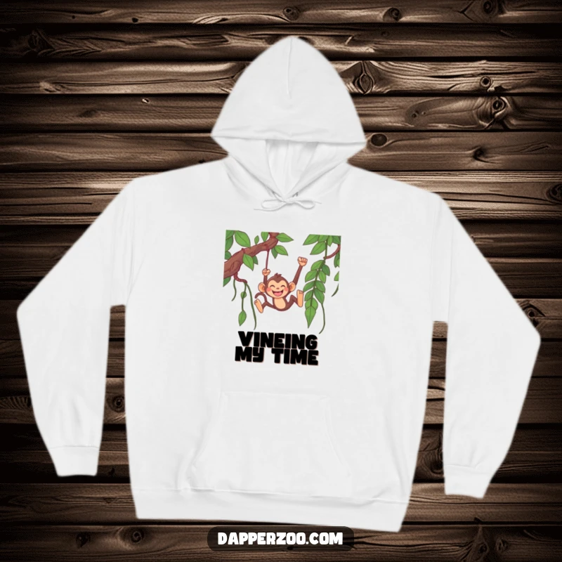 Funny monkey hoodie featuring a happy monkey character grinning widely while swinging from an excessively long jungle vine.