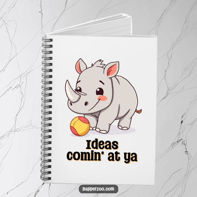 Funny rhinoceros calf notebook featuring a happy calf playfully nudging a small, colorful ball.