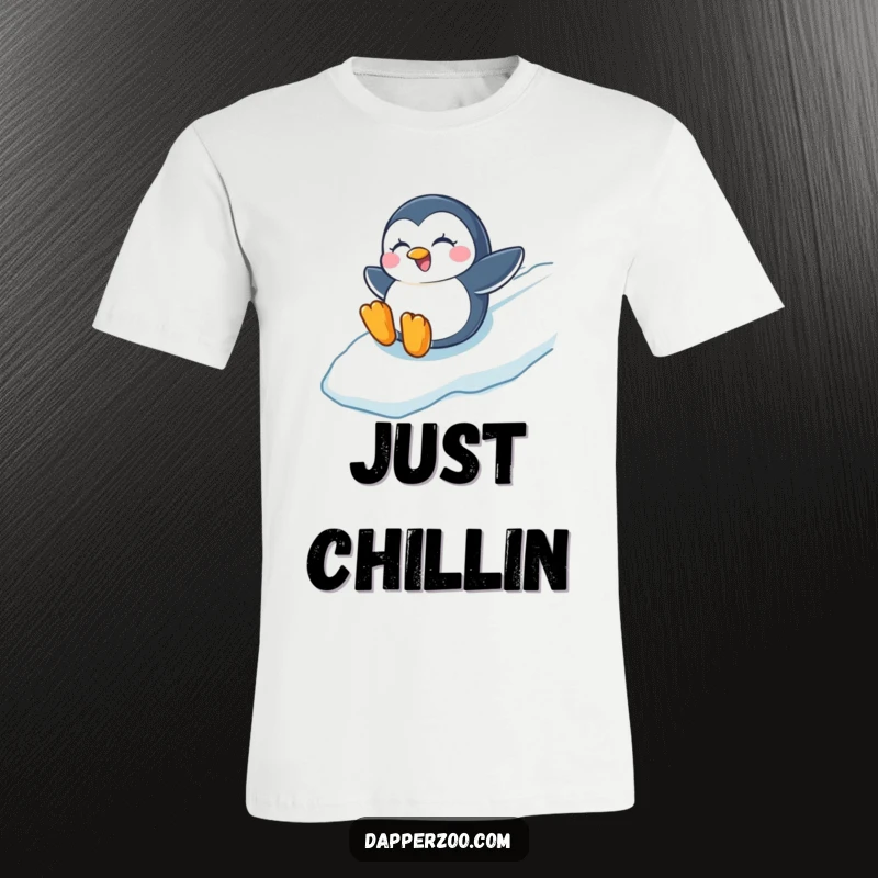 Funny t-shirt depicting a winking penguin gleefully sliding down a snowy icy slope, embodying pure winter joy and fun.