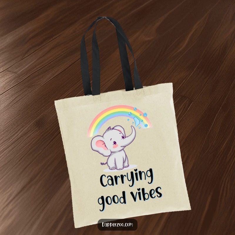 A tiny elephant sprays water from its trunk to create a rainbow on this funny tote bag, practical and cute.