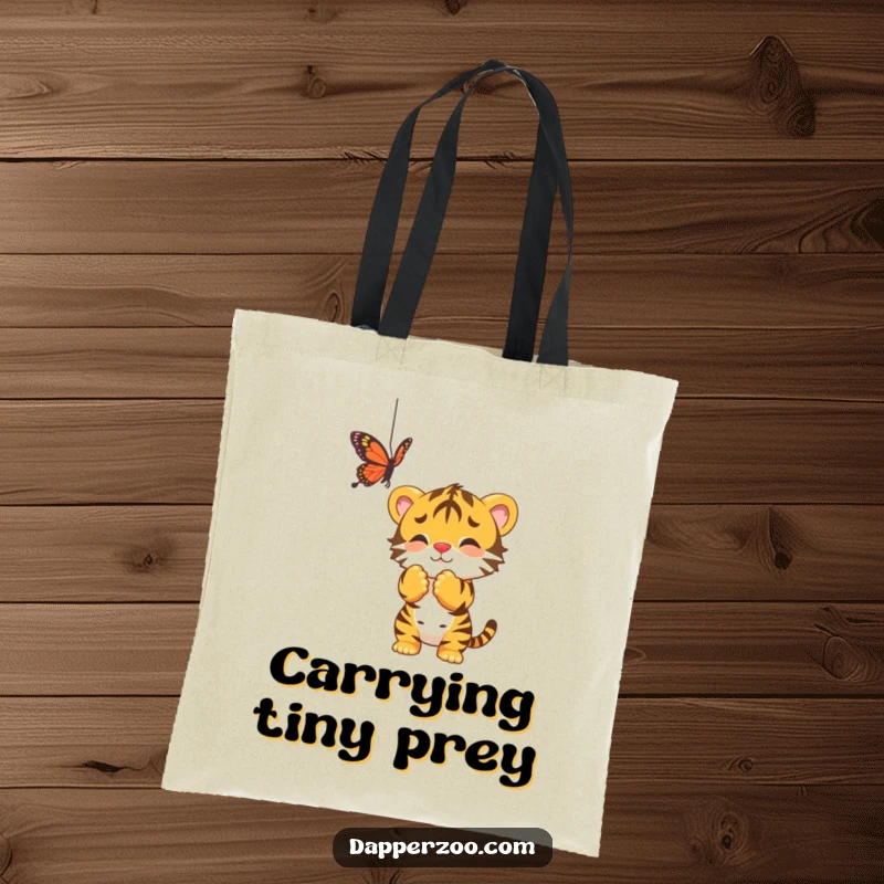 Funny tote bag with a playful tiger cub batting at a dangling butterfly, a charming design for little explorers.
